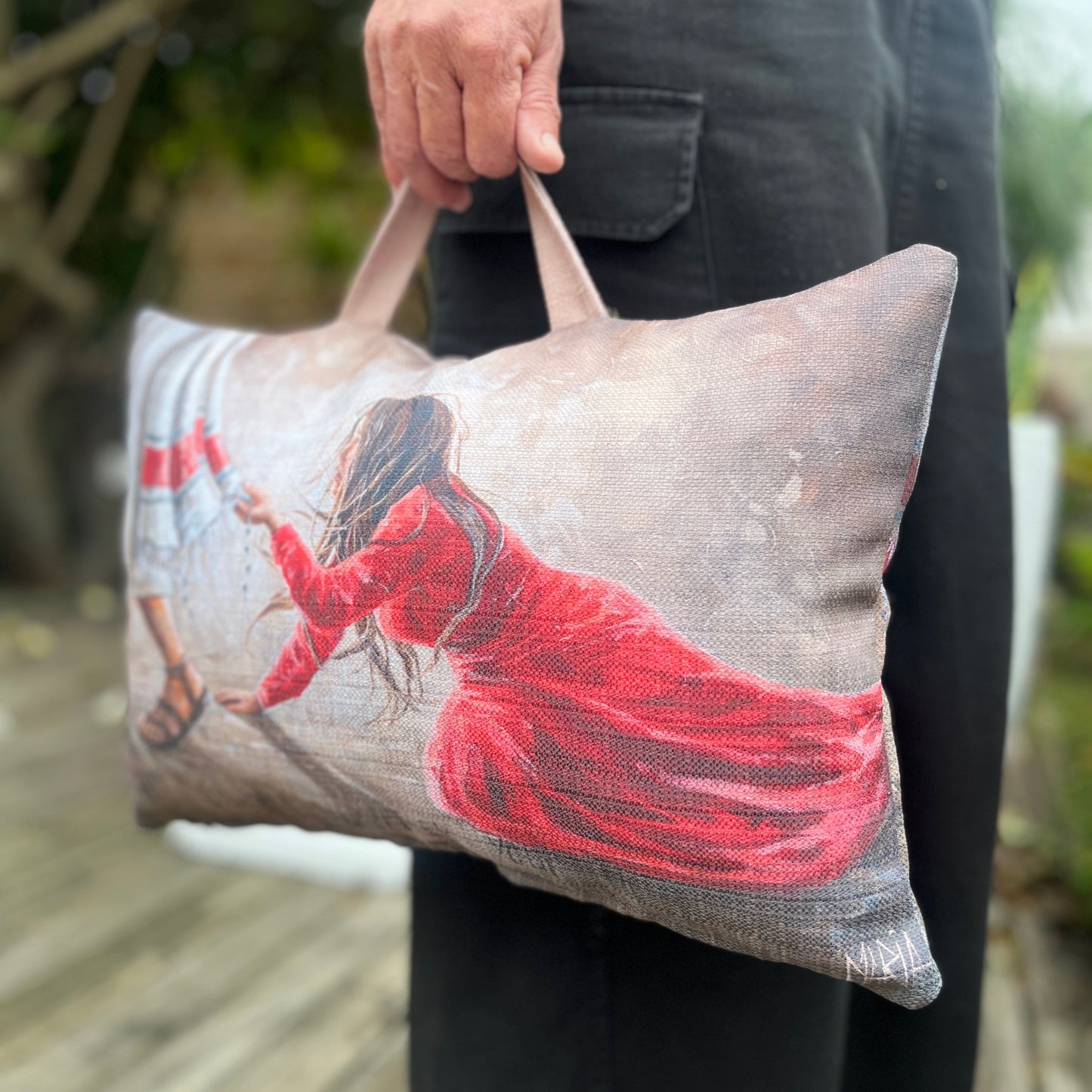 Person holding a pillow with a printed House Of Maria spiritual gift prayer cushion close up