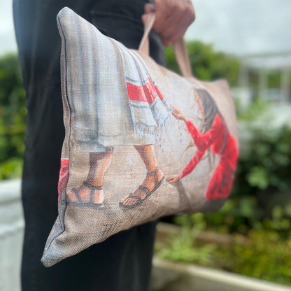 Biblical art kneeling cushion with carry handle Person holding a cushion with a printed design of two people shaking hands.