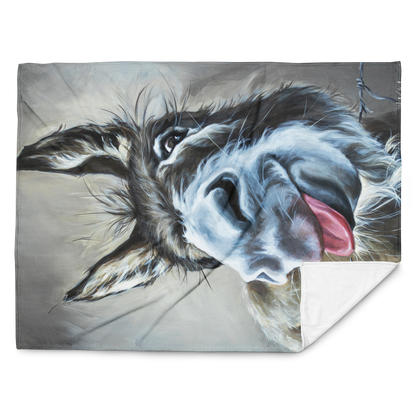 Fleece blanket with a dog's face design on a gray background
