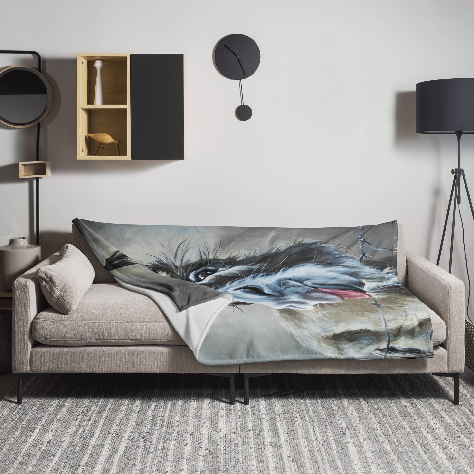 Sofa with a decorative blanket featuring an artistic depiction of a horse's head in a modern living room.