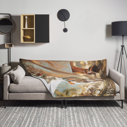 Sofa with a decorative blanket featuring artistic design in a modern living room.